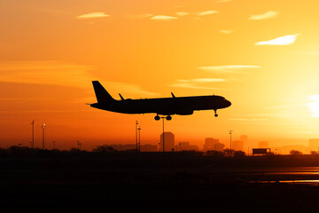 Passenger aircraft silhouette against a brilliant Texas sunrise