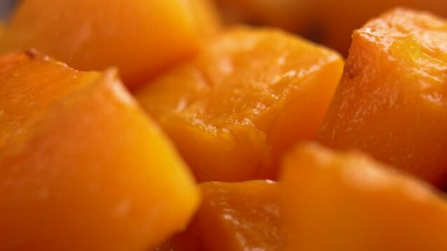 Baked pumpkin slices. Roasted butternut squash. Healthy vegan food. Macro shot. Rotation