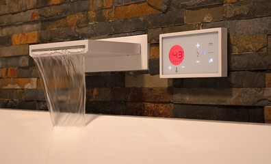 Modern digital watertap, filling the white bath