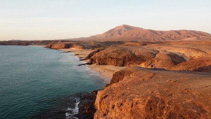 Coastline Atlantik Ocean view from above. Sunset above Mountain and Ocean. Canary Islands. Lanzarote 