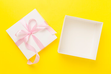 White open gift box on color background, top view. Mock up for design