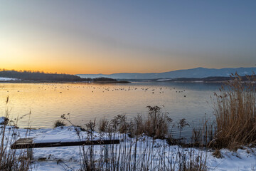 Milada lake with color frosty sunset and blue sky