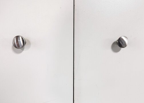 White cabinet doors with brushed nickel pull knobs
