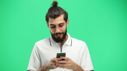 Man, close-up, on a green background, with a phone