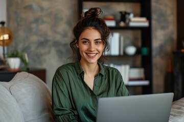 Beautiful woman using digital tablet and smiling while sitting at her working place in office