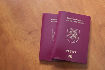 Two Lithuanian passports are placed on the table.
