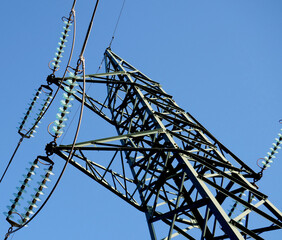 An electric pylon with blue sky in the background