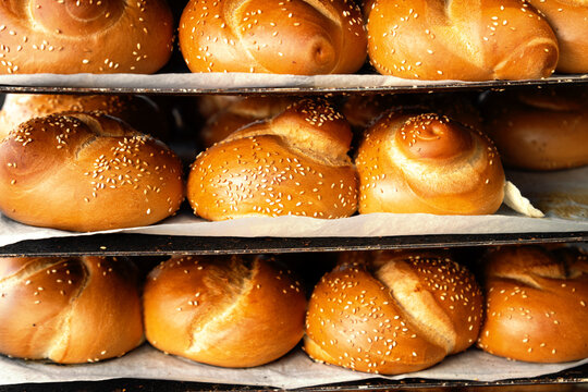 Background with traditional israeli bread hala on the bakery shelves close up