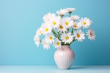  a pink vase filled with white daisies on top of a light blue table next to a light blue wall.