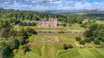 Drumlanrig castle, Scotland encompassed by vast greenery