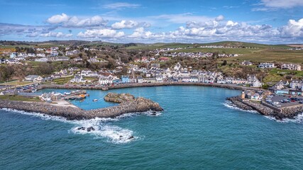 Portpatrick harbour, Scotland with docked boats along the shore © Wirestock
