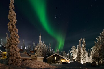 Winter landscape with aurora borealis on the background, Lapland, Finland 