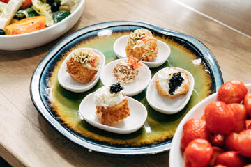 Sesame cheese balls. Profiteroles with cream and caviar, luxury catering.