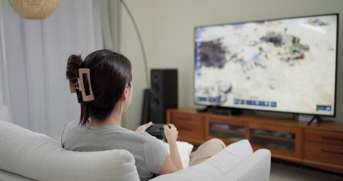 Woman play video game at home