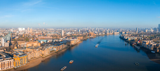 Fototapeta premium Aerial view of the Iconic Tower Bridge connecting Londong with Southwark on the Thames River in London, UK.