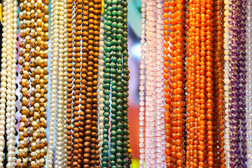 Puttaparthi, India. Indian traditional handicraft (glassbeads) on the street market.