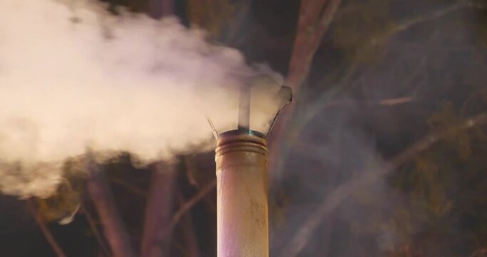 Stove pipe. Smoking chimney. Smoke and carbon dioxide emissions from chimney because of burning wood, exhaust gas emissions, atmospheric pollution, problem of global warming and climate change