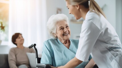 Obraz premium Young female carer sharing a laugh with an elderly woman in Nursing Home. Concept, caring for the elderly.