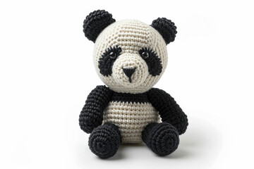 Amigurumi little panda bear. Handicraft cute crocheted doll. Isolated on white background.