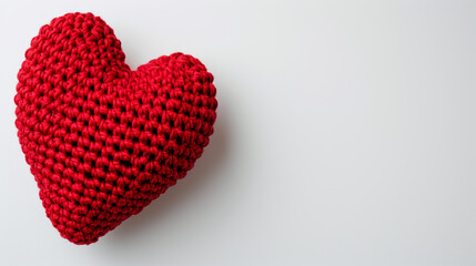 Fototapeta premium Amigurumi little heart. Handicraft cute Crocheted doll. Isolated on white background. Love symbol postcard, health concept or Valentine's day banner.