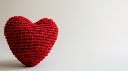 Fototapeta premium Amigurumi little heart. Handicraft cute Crocheted doll. Isolated on white background. Love symbol postcard, health concept or Valentine's day banner.