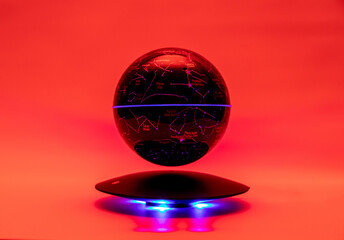Decorative night light: a round ball with multi-colored lighting to create an atmosphere, on a red background