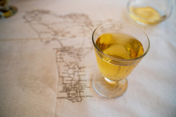 White wine kept on a table with out of focus south america map in the background, wine production country concept