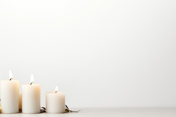 Fototapeta na wymiar white candles on the right, white background, space 2/3 for text 