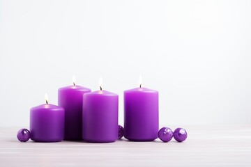 Obraz na płótnie Canvas purple candles on the right, white background, space 2/3 for text on the right