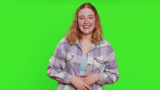 Amused lovely woman pointing finger to camera, laughing out loud, taunting making fun of ridiculous appearance, funny joke anecdote. Pretty redhead girl isolated alone on green chroma key background