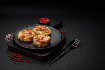 Delicious baked fish fillet with cheese, tomatoes, salt, spices and herbs