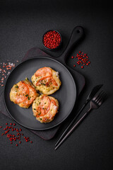 Delicious baked fish fillet with cheese, tomatoes, salt, spices and herbs