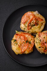 Delicious baked fish fillet with cheese, tomatoes, salt, spices and herbs