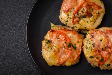 Delicious baked fish fillet with cheese, tomatoes, salt, spices and herbs