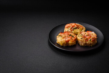 Delicious baked fish fillet with cheese, tomatoes, salt, spices and herbs
