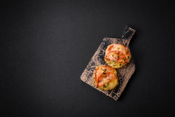 Delicious baked fish fillet with cheese, tomatoes, salt, spices and herbs