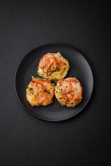 Delicious baked fish fillet with cheese, tomatoes, salt, spices and herbs