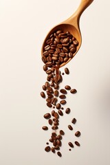 coffee beans in a spoon on a beige background 