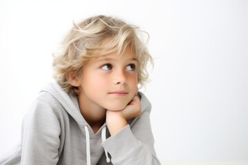 Portrait of a thoughtful little boy. Isolated on white background.