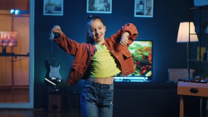 Children content creator using professional recording equipment to film dancing video for online streaming platforms. Young media star does viral choreography for her generation z fanbase