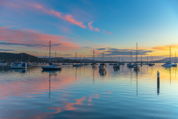 Fototapeta premium Sunrise, boats and reflections on the water