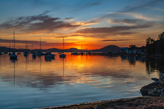 Sunrise, boats and reflections on the water