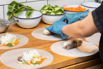 Chef Preparing Spring Rolls in Restaurant Kitchen