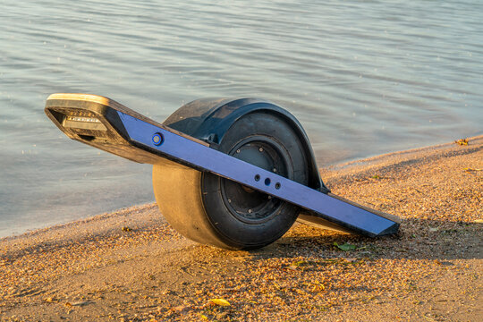One-wheeled electric skateboard (personal transporter) on a lake shore in Colorado