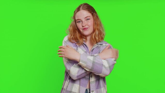 Come to me, I want to embrace you. Smiling young woman spread hands and give hug to you. Pleasant expression, love feelings, proud, satisfied. Girl isolated on green chroma key background. Lifestyles