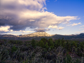 Fototapeta premium Mountain peak in sunset clouds. Dirfi mountain is located in Euboea island, Greece 