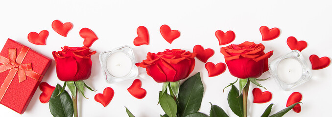 Bouquet of red roses, hearts and candles on a white background. Valentine's day February 14. Place for your text.