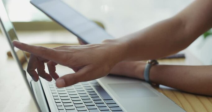 Hands, tablet and touchscreen laptop in office, digital and scroll on screen with fingers to research. Person, technology and ui in project management, online and ux on smart electronics in workplace