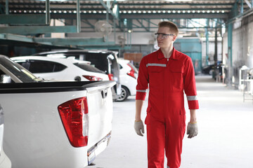 Auto mechanic working in garage. Repair service. Worker mechanics in uniform are working in auto...