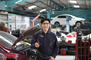 Auto mechanic working in garage. Repair service. Worker mechanics in uniform are working in auto...